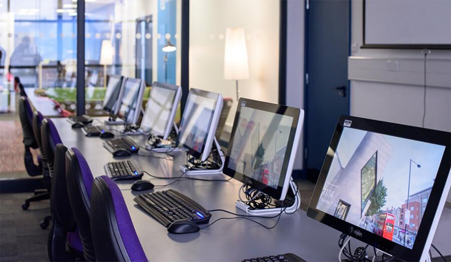 A row of computers in a technology lab.