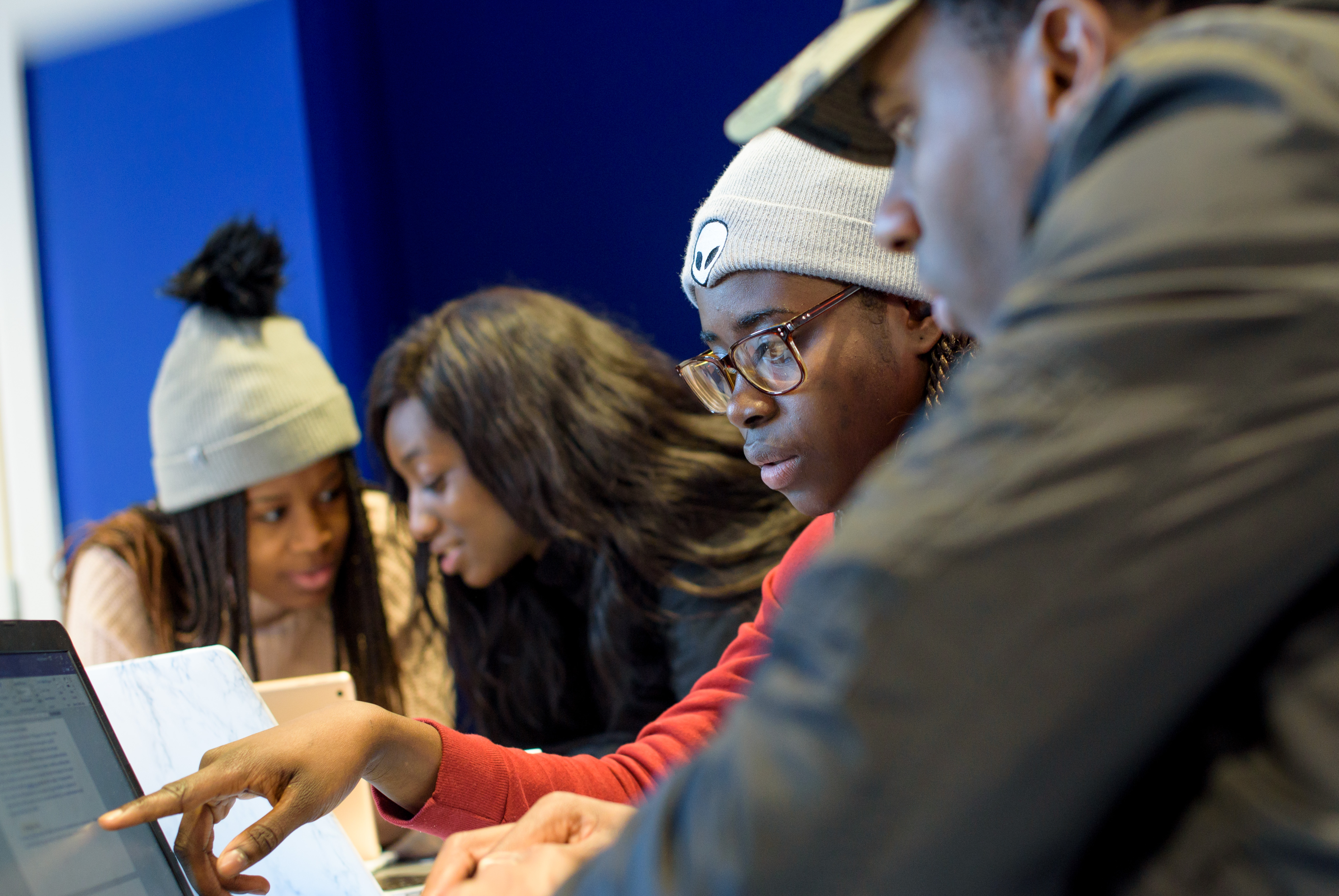 Students sitting around laptop