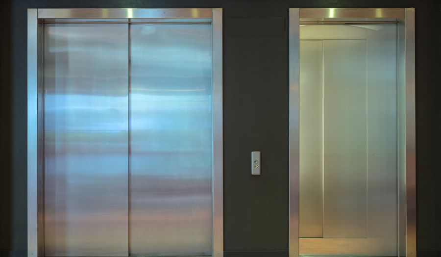 Two lift doors, one open and one closed