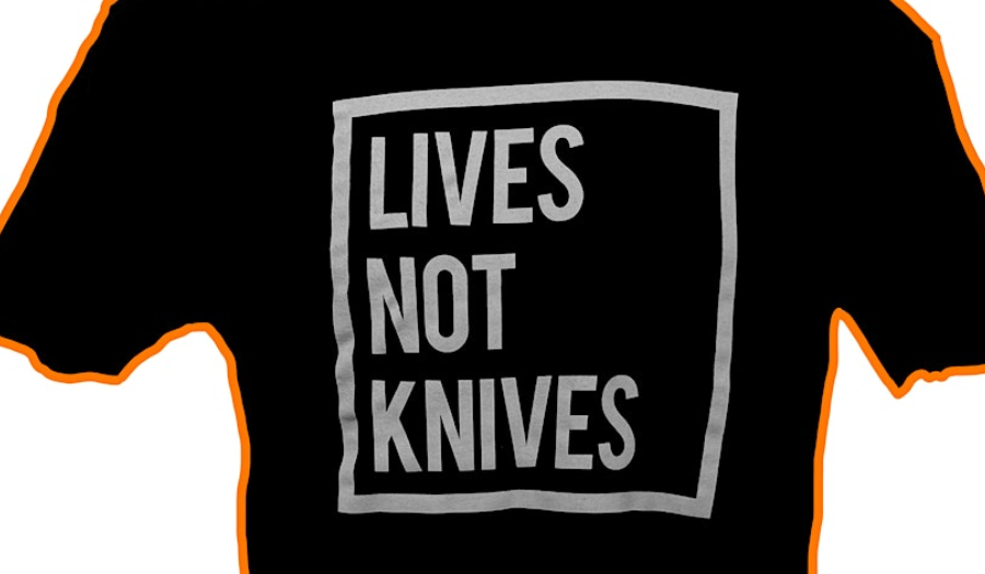 The words 'Lives not knives' on a t-shirt