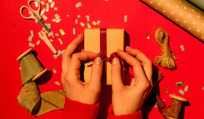 Hands wrapping a gift box 