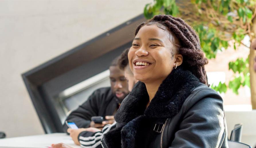 female student smiling with colleague