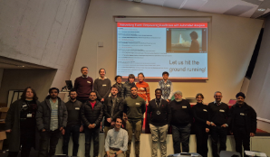 Group of participants in front of a projector in the graduate centre