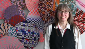 A photo of a woman against a colourful background