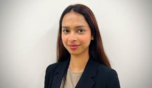 A head and shoulders portrait of Shrabani, who has long dark hair and is wearing a dark jacket.