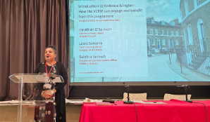 Woman presenting in front of a projector