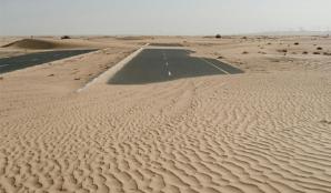 Sand dunes covering an abandoned road